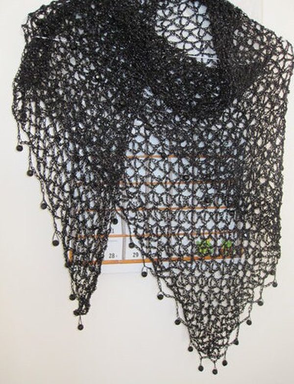 Black beaded crochet shawl hanging flat, full triangular view with beaded points along the hem.